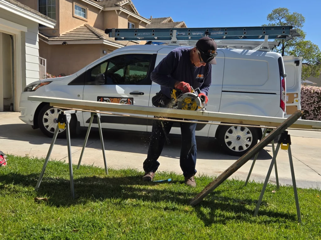 Termite crewperson cutting wood in Corona, CA