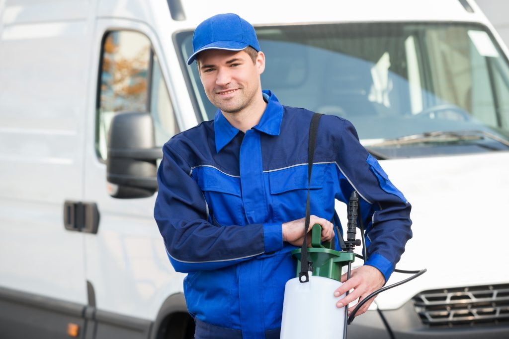 Pest Control technician holding a spray tank